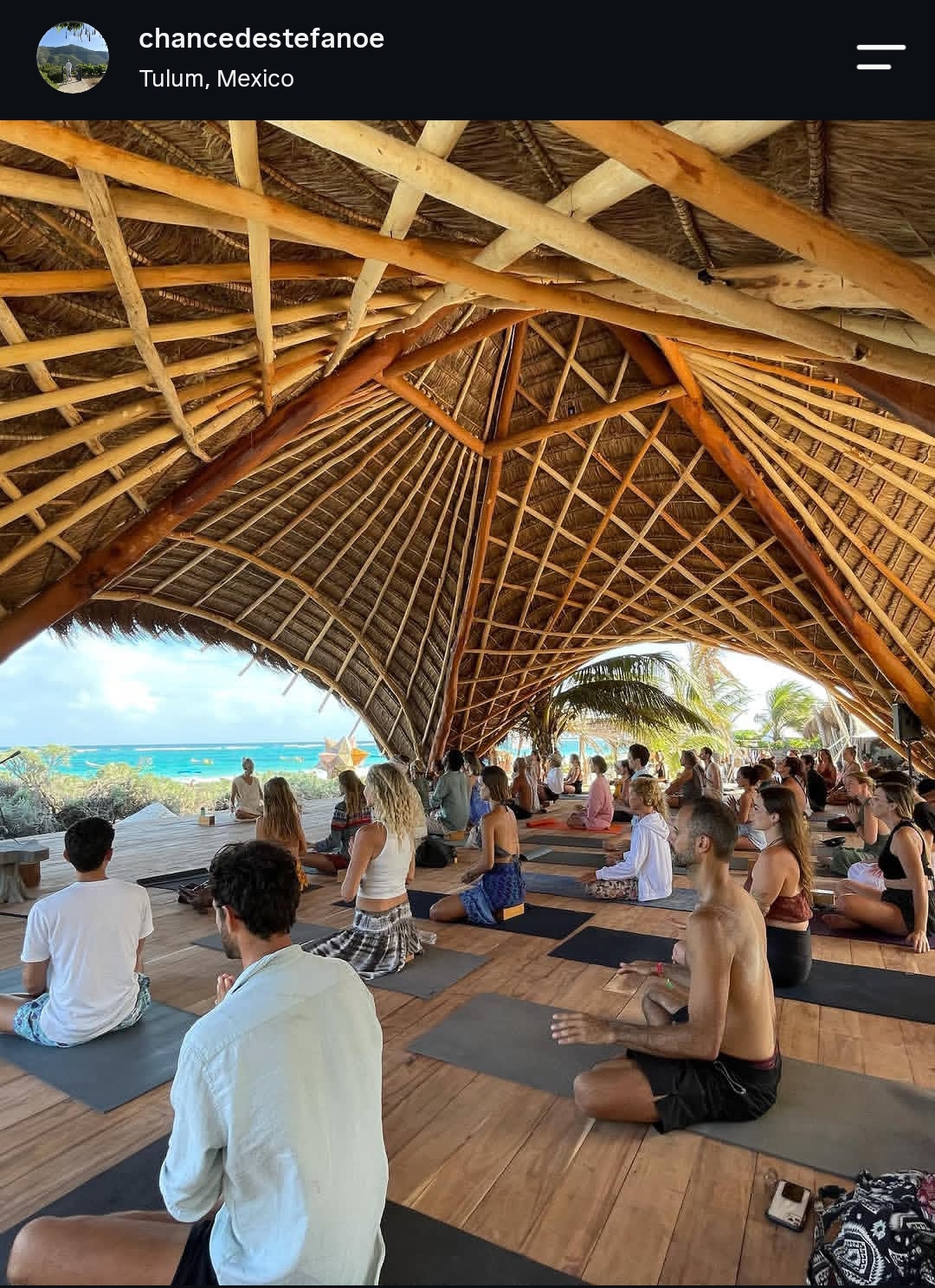 Group meditation under a bamboo dome in Tulum