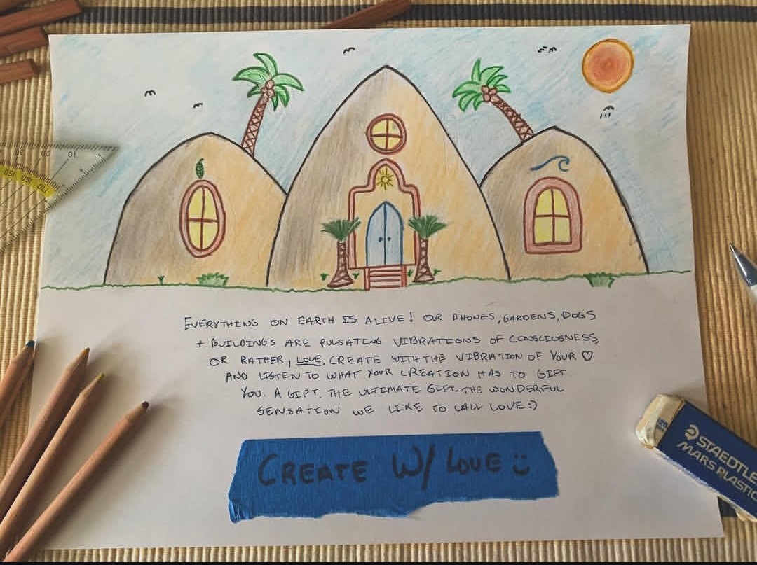 Hand-drawn sketch of three earthen domes with palms and the words Create with love